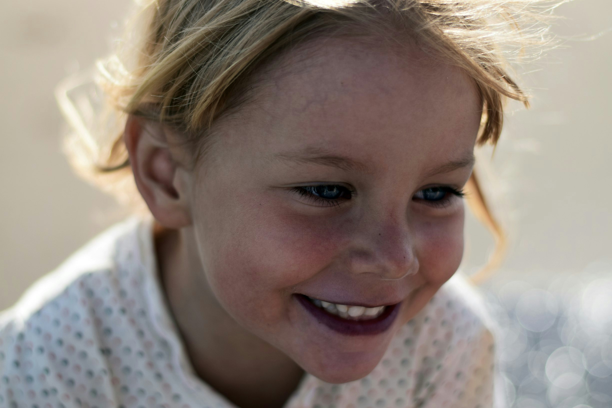 selective focus photo of young smiling girl